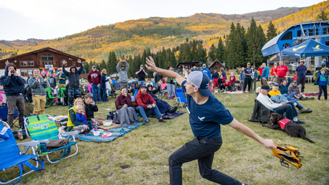 An employee throws a backpack to the crowd during Big Cottonwood Winter Welcome at Solitude Mountain Resort