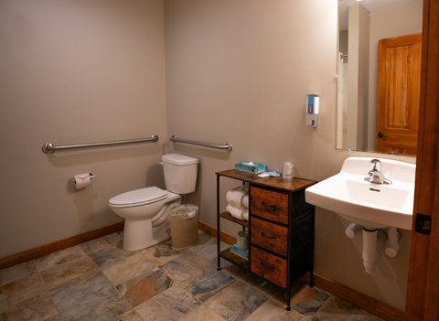 accessible hotel bathroom with wide layout and rustic vanity at black bear lodge located at stratton mountain resort