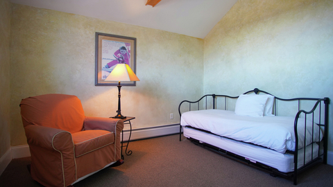 cozy reading nook with armchair and daybed in landmark 315 vacation rental at stratton mountain resort