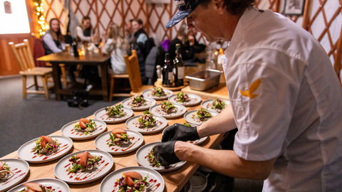 Guests enjoy dinner after snowshoeing to The Yurt at Solitude.