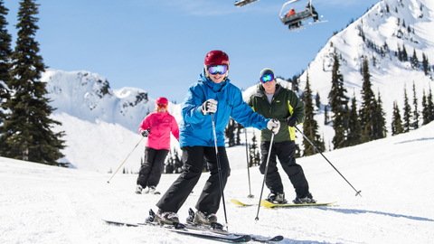 A trio of skiers enjoy their trip down a run