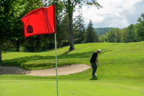 golf lifestyle course club boys friends guests smile laugh green apron pro shop music green fairway put drive chip
