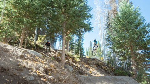 Two mountain bikers ride Pyrite Plunge at Solitude Bike Park.