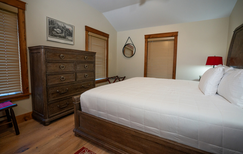 quiet bedroom with wood furnishings and natural light at 34 saw mill vacation rental at stratton mountain resort