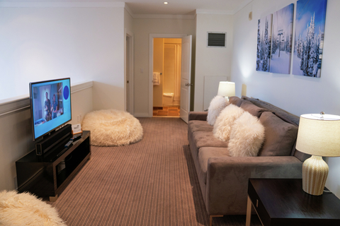 living room with plush sofa and flat screen tv at rising bear lodge vacation rental at stratton resort