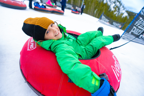 Kid snow tubing in Colorado at Winter Park Ski Resort