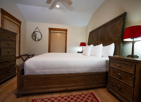king-size bed and rustic decor featured at 34 saw mill vacation rental at stratton mountain resort