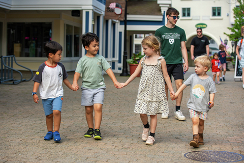 group of kids walking in the Village at stratton resort during a sunny afternoon, enjoying outdoor activities as part of the summer camp for kids
