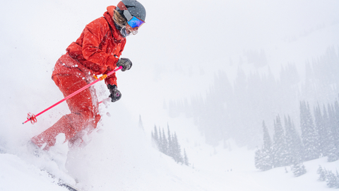 Stoked skier shreds through powder