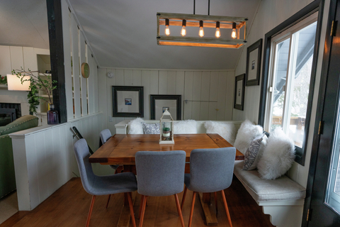 cozy dining nook with wood table and built-in bench seating at 22 north branch vacation rental