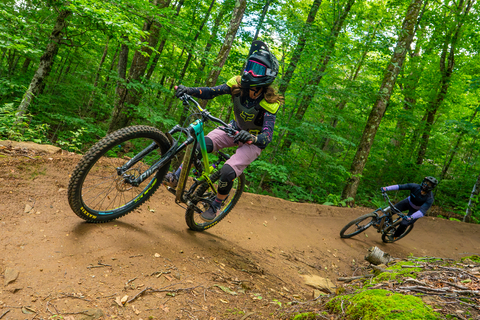 Two mountain bikers riding the downhill bike park trails at Stratton, Vermont's mountain bike park