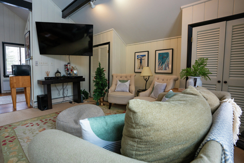 comfortable living space with oversized armchairs and a wall-mounted tv at 22 north branch vacation rental