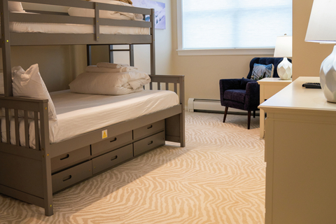 bunk bed guest room with cozy seating at rising bear lodge vacation rental at stratton mountain resort