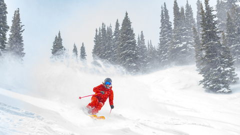 Skier turns through powder. 
