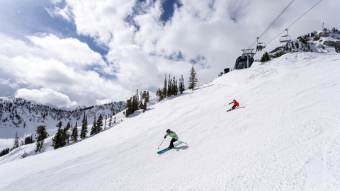  Two friends ski near the top of Summit Express at Solitude Mountain Resort.