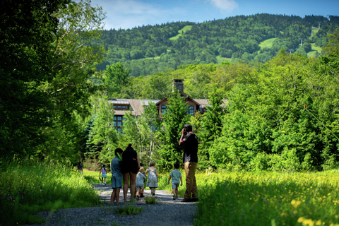 Kids waling to camp at stratton resort during a sunny afternoon, enjoying outdoor activities as part of the summer camp for kids