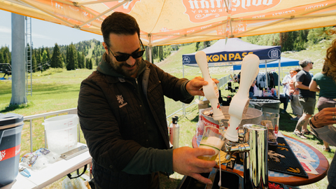 A bartender pouring a beer during Big Cottonwood Canyon Brew Fest at Solitude Mountain Resort.