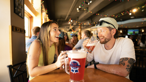 People enjoying food, drinks, and games at Thirsty Squirrel
