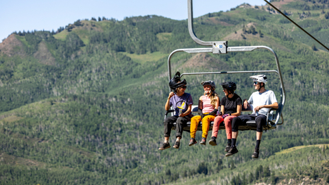 Four friends ride Moonbeam Express at Solitude Bike Park.