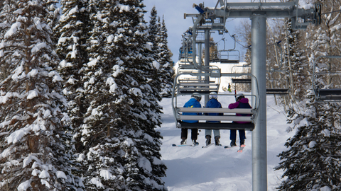 Skiers ride Apex Express chairlift at Solitude Mountain Resort