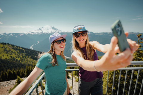 Two women pose for a selfie in front of Mt. Rainier atop the Scenic Gondola at Crystal Mountain