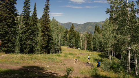 Friends play disc golf at Solitude Mountain Resort