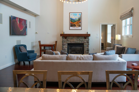 spacious living area with fireplace and mountain artwork at rising bear lodge vacation rental at stratton resort