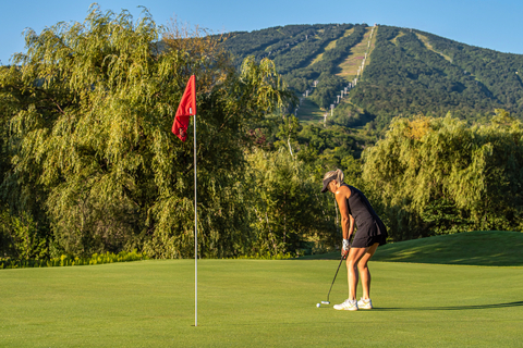 golfer hitting a putt at the stratton golf course