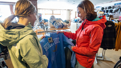 A mother and daughter shop for a sweatshirt in the village Canyon Fever retail location at Solitude Mountain Resort.