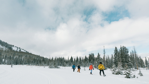 Friends snowshoeing at the Solitude Nordic Center.