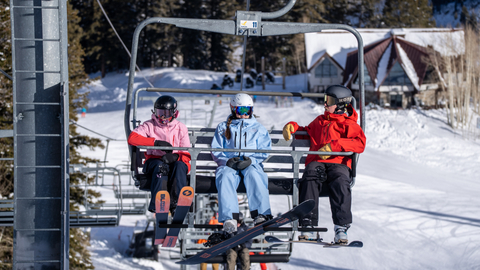 Skiers and snowboarders ride the chairlift at Solitude Mountain Resort