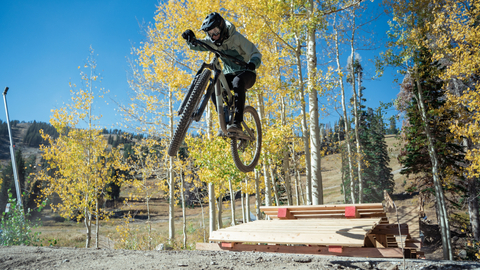 A mountain bike team rider catches air in Solitude Bike Park