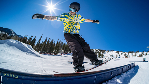A snowboarder rides a rail in Solitude's Main Street Terrain Park