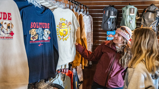 Two friends shop at the Village Canyon Fever retail location and Village Store at Solitude Mountain Resort.