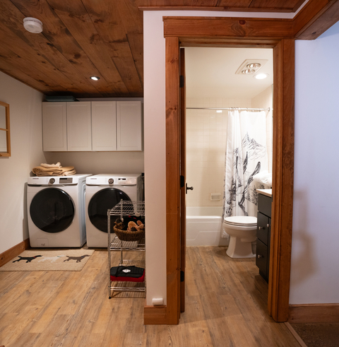 laundry area and adjacent full bathroom at 34 saw mill vacation rental, offering homestyle convenience at stratton resort