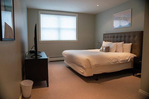 primary bedroom with king bed and soft lighting at rising bear lodge vacation rental at stratton mountain resort