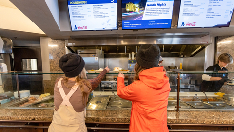 Two friends get served their lunch at Roundhouse Lodge at Solitude Mountain Resort. 