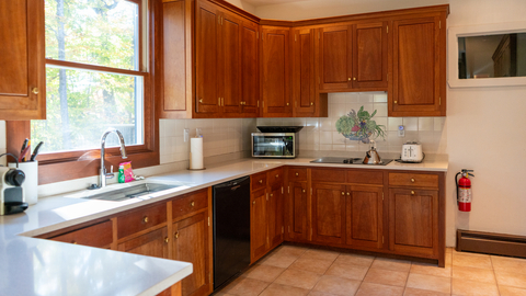 fully equipped kitchen with warm wood cabinetry and natural light at 19 middle ridge vacation rental