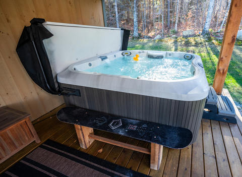 outdoor hot tub on the covered deck at 34 saw mill vacation rental, perfect for relaxing after a day at stratton resort