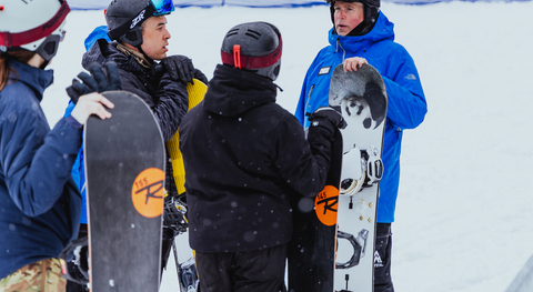 Coach gives speech to snowboard participants