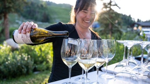 A server pours glasses of wine at St. Bernard's Dinner & Wine Pairing Series