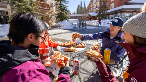 Four friends enjoy lunch outside at Stone Haus at Solitude Mountain Resort. 