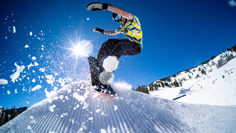 A freestyle rider slashes a feature in a Solitude terrain park