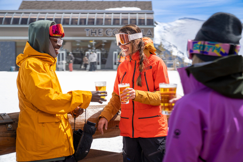 Adults at Sunspot Mountaintop Lodge at Winter Park Ski Resort drinking a beer