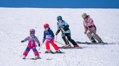 A family skis during Kids Ski Free Week at Solitude Mountain Resort.