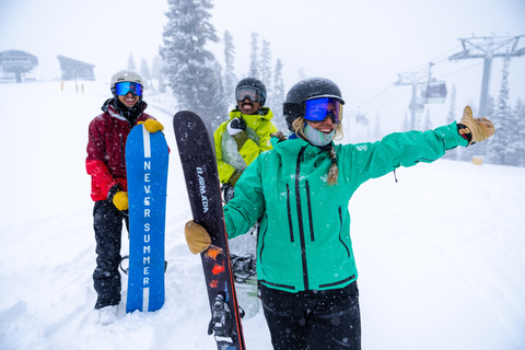 Group of 3 people at the top of Winter Park Resort on a snow day
