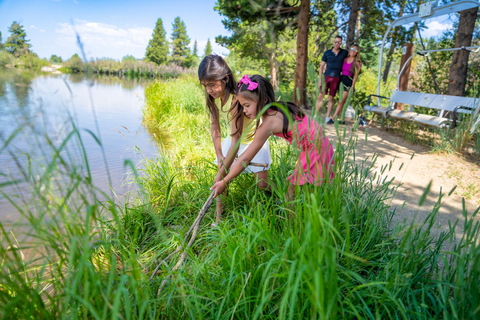 Children fishing with parents at a pond in Winter Park