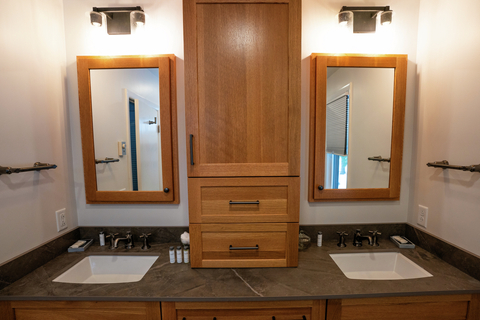 spacious dual sink bathroom with wood cabinetry at 22 north branch vacation rental near stratton mountain