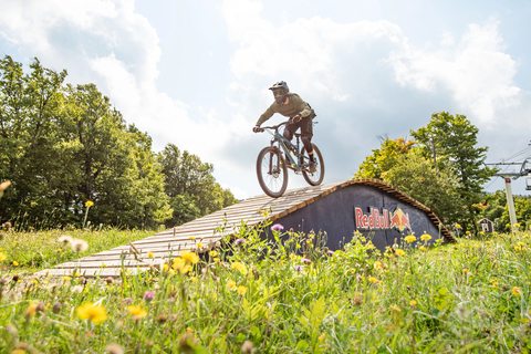 Mountain Biker riding over a wooden ramp feature in the stratton bike park