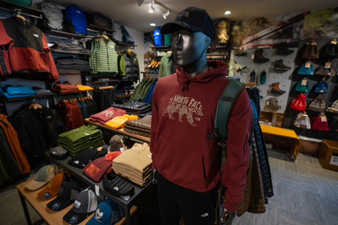 hooded sweatshirt and hats from the north face with jackets hanging in the background in the stratton village